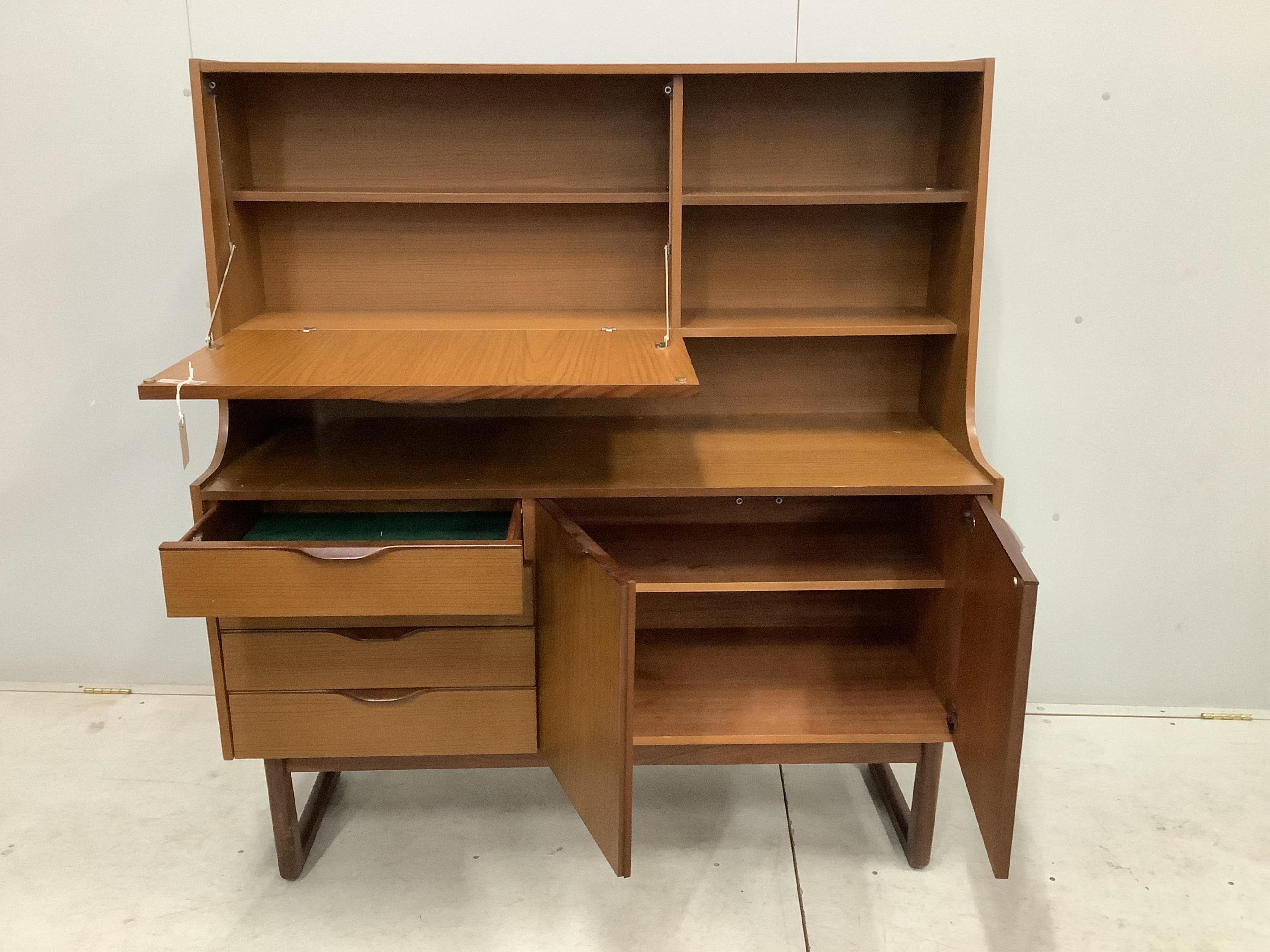 A mid century 'Europa Furniture' simulated teak sideboard, width 125cm, depth 46cm, height 138cm. Condition - fair